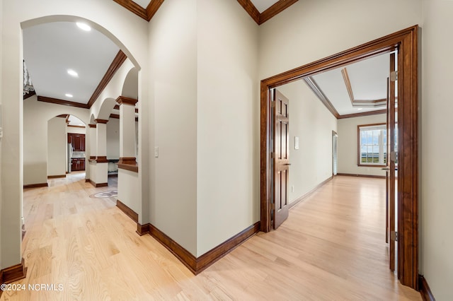 corridor featuring crown molding and light hardwood / wood-style flooring