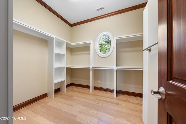 spacious closet with light hardwood / wood-style floors