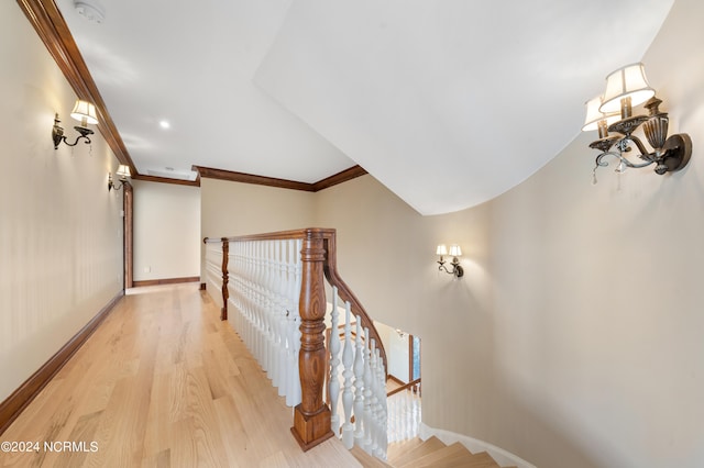 staircase featuring ornamental molding and wood-type flooring