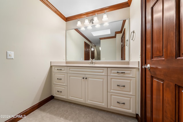 bathroom featuring vanity, ornamental molding, and a skylight