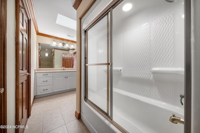 bathroom with tile patterned floors, crown molding, vanity, shower / bath combination with glass door, and a skylight