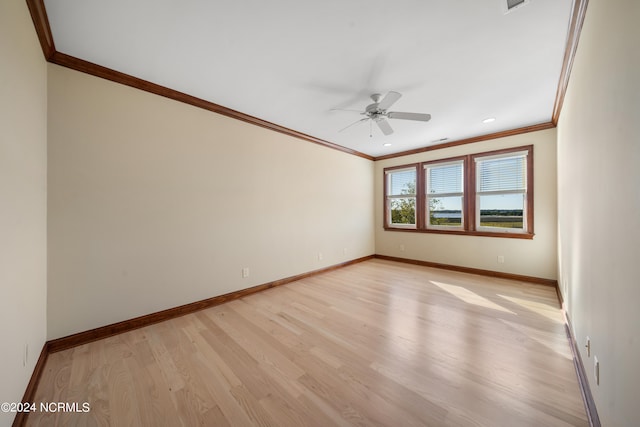 spare room featuring crown molding, light wood-type flooring, and ceiling fan