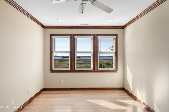 empty room with crown molding, light hardwood / wood-style floors, a healthy amount of sunlight, and ceiling fan