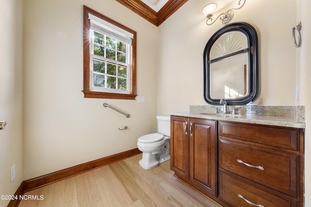 bathroom with vanity, toilet, ornamental molding, and wood-type flooring