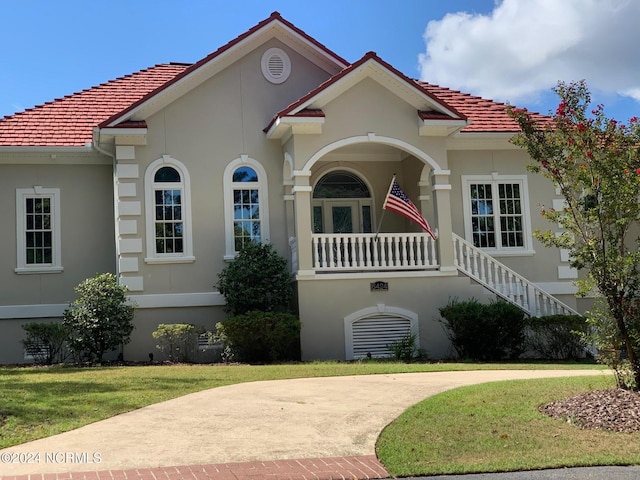 mediterranean / spanish-style home with a front yard