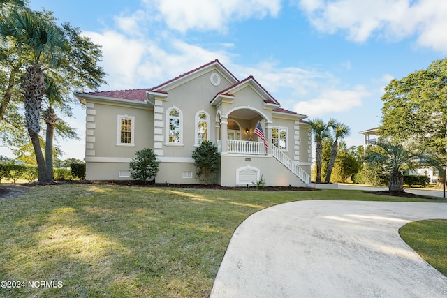 mediterranean / spanish-style house with a front lawn and a porch