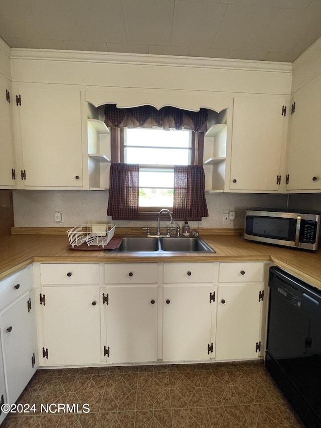 kitchen with white cabinetry, black dishwasher, sink, and crown molding