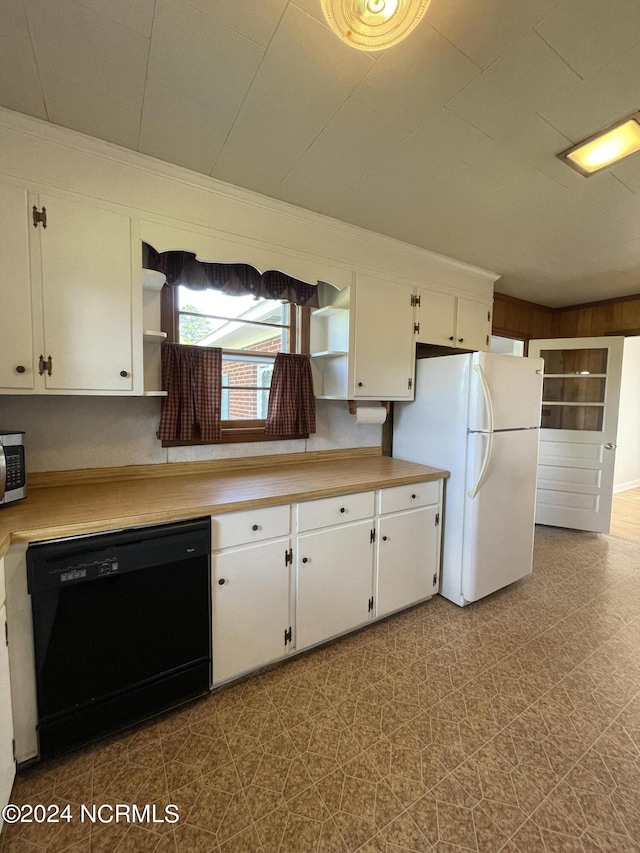 kitchen featuring white cabinetry, crown molding, black dishwasher, and white fridge