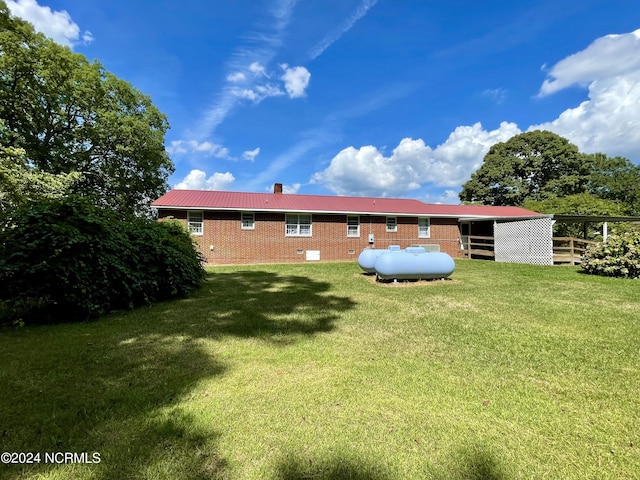 rear view of house with a yard