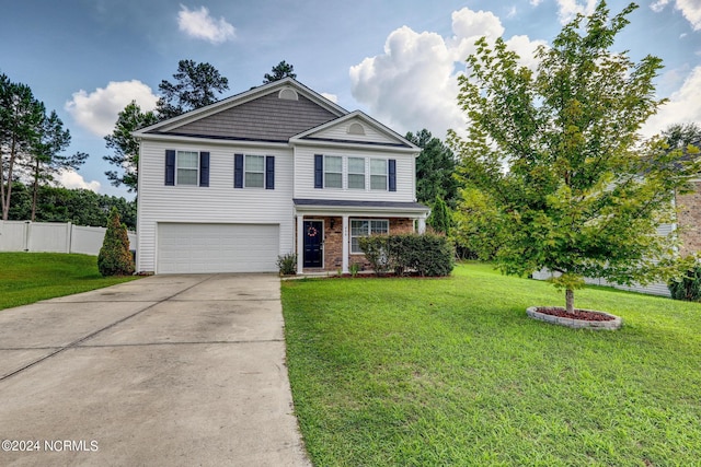 view of property featuring a garage and a front yard