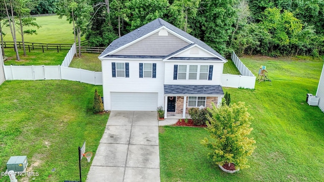 view of front of house with a garage and a front lawn