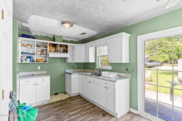 kitchen featuring white cabinetry, a wealth of natural light, sink, and dark hardwood / wood-style floors