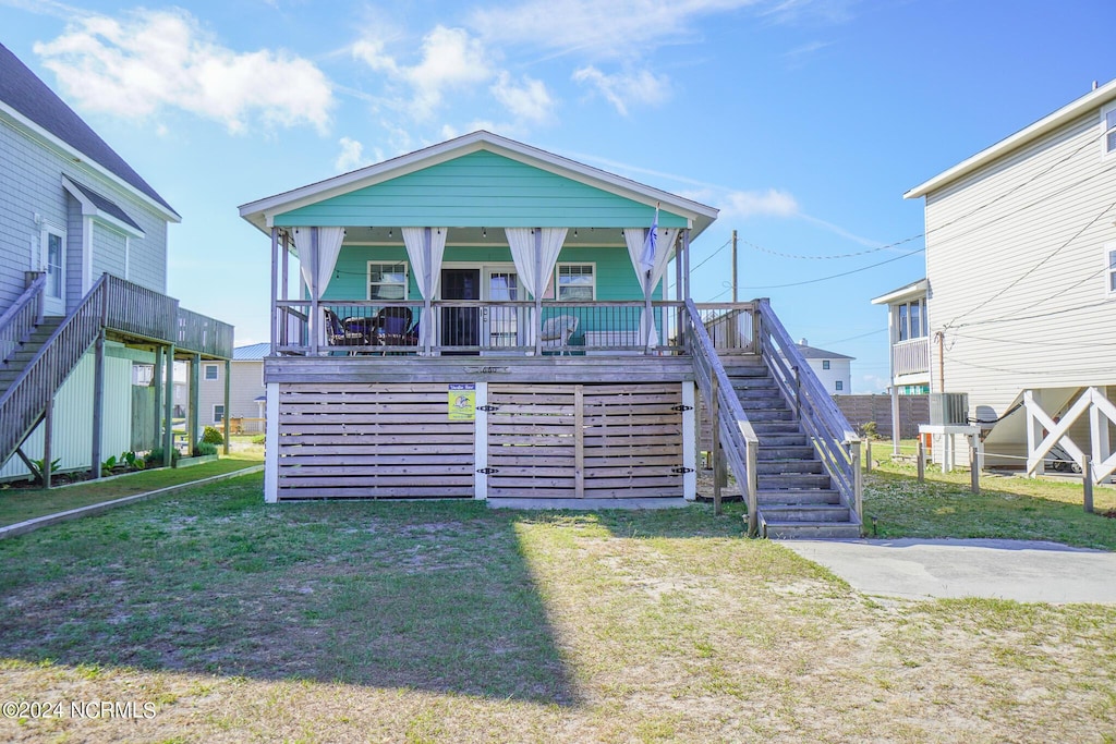 view of front of home with covered porch and a front lawn