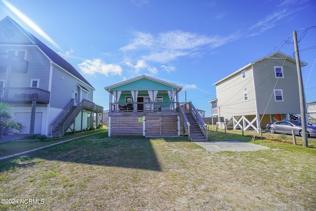 back of property featuring a lawn