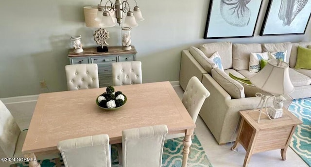 carpeted dining space with an inviting chandelier