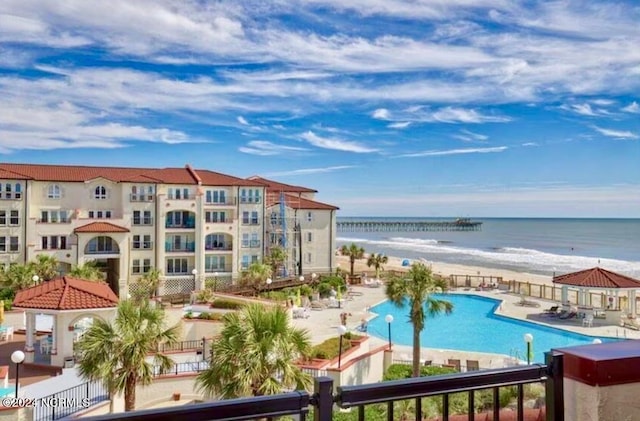 exterior space featuring a patio, a water view, and a community pool