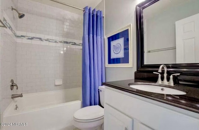 full bathroom with vanity, toilet, and shower / tub combo with curtain