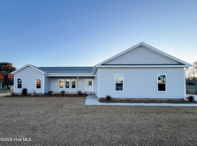 ranch-style home featuring a front yard