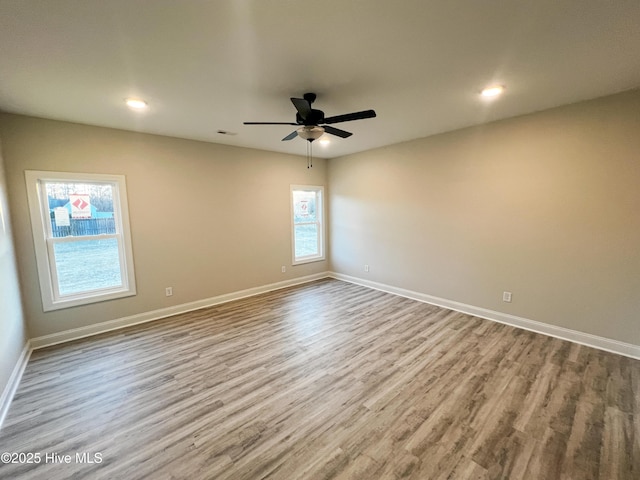 unfurnished room with light hardwood / wood-style flooring and ceiling fan