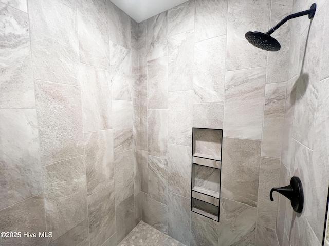 bathroom with a tile shower