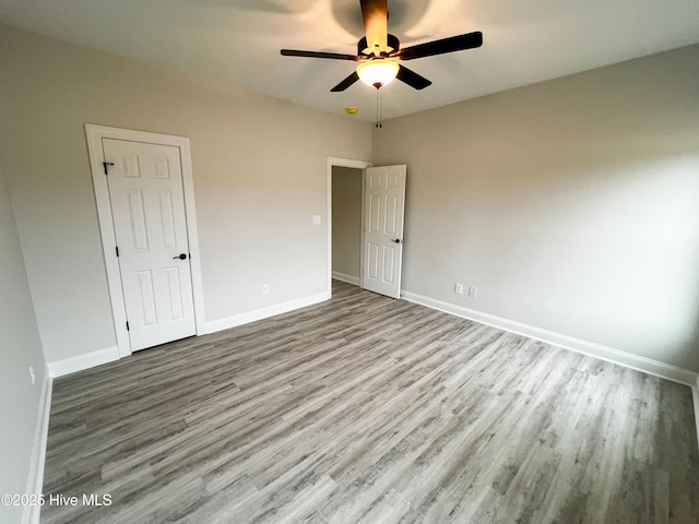 unfurnished bedroom featuring ceiling fan and light hardwood / wood-style flooring