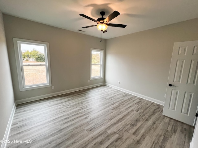 spare room with ceiling fan and light hardwood / wood-style flooring