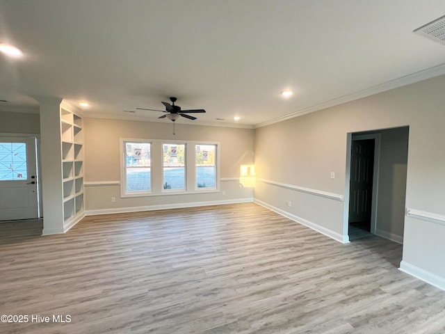 unfurnished living room with light hardwood / wood-style floors, built in features, and crown molding