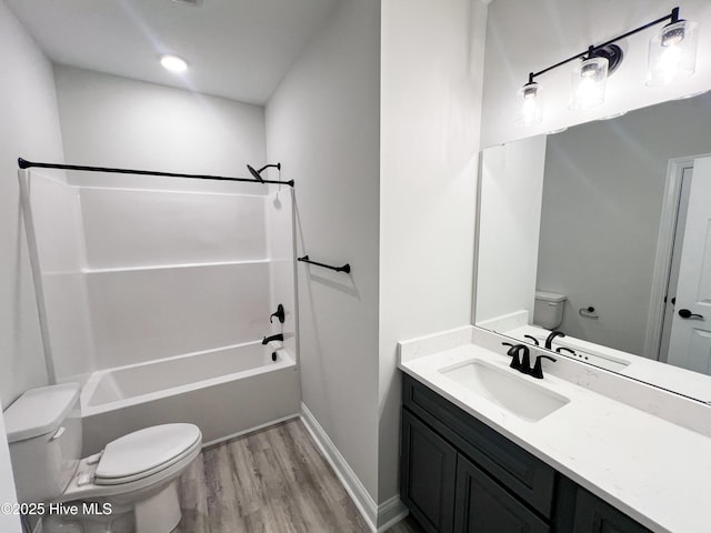 full bathroom featuring vanity, toilet, wood-type flooring, and shower / washtub combination