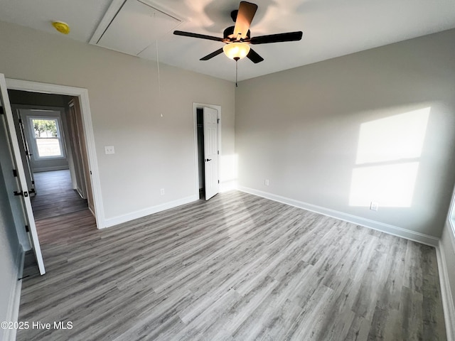 empty room with ceiling fan and hardwood / wood-style flooring