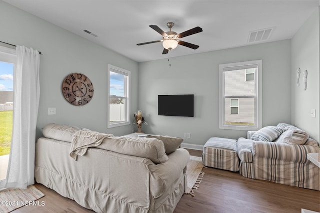 bedroom featuring multiple windows, ceiling fan, and hardwood / wood-style floors