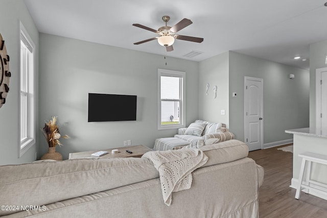 living room with dark hardwood / wood-style floors and ceiling fan