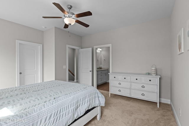 carpeted bedroom featuring ceiling fan and connected bathroom