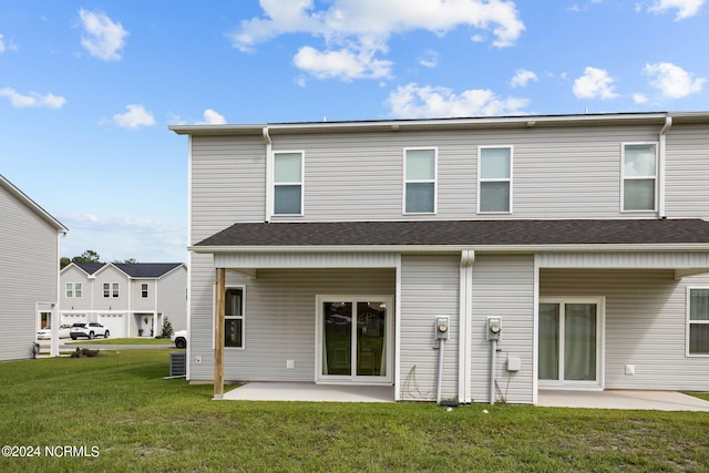 rear view of house with a yard and a patio