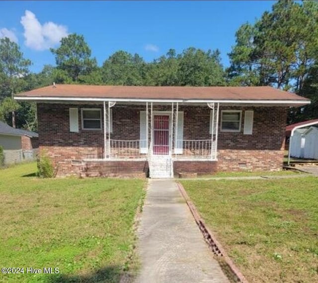 ranch-style house featuring a front yard and a porch