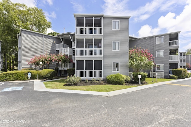 view of property featuring uncovered parking