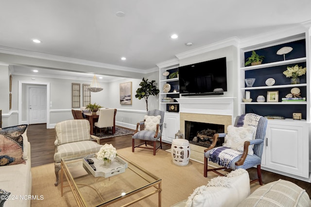 living room featuring recessed lighting, wood finished floors, a high end fireplace, and crown molding