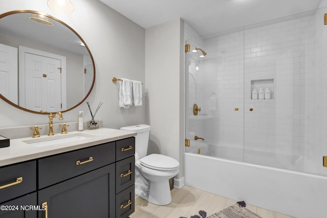 full bathroom with toilet, tub / shower combination, wood finished floors, and vanity