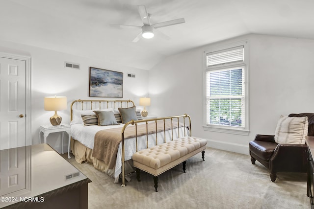 bedroom with a ceiling fan, lofted ceiling, visible vents, and carpet