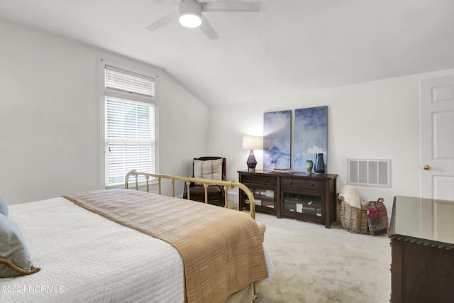 bedroom featuring visible vents, vaulted ceiling, light carpet, and ceiling fan