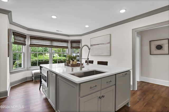 kitchen featuring crown molding, gray cabinets, light countertops, paneled dishwasher, and a sink