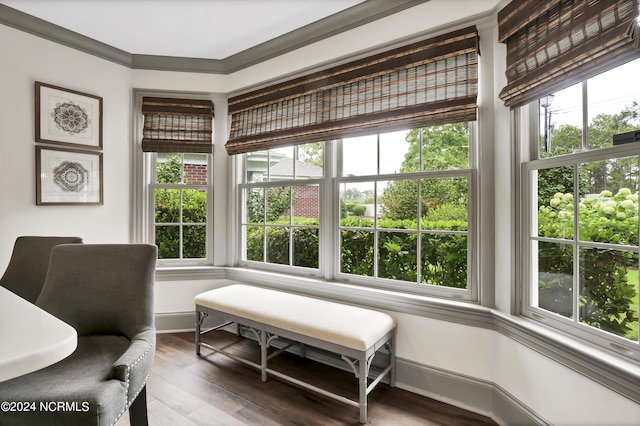 sitting room featuring crown molding, wood finished floors, and baseboards