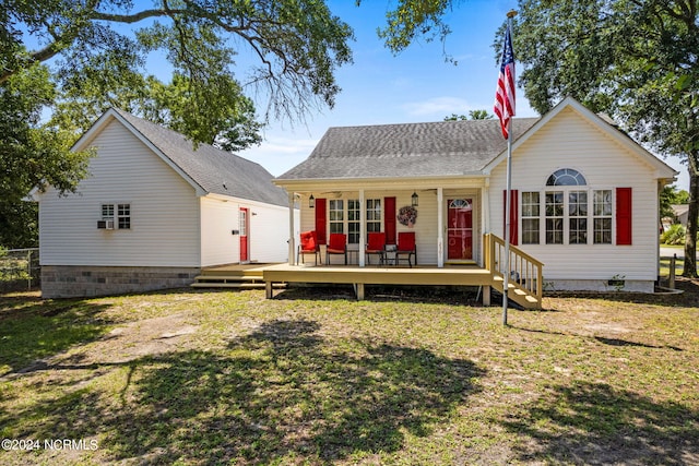 view of front facade featuring a deck and a front yard