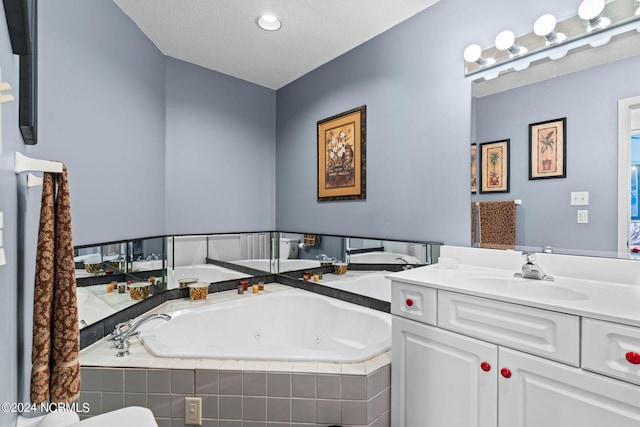 bathroom featuring vanity and tiled bath