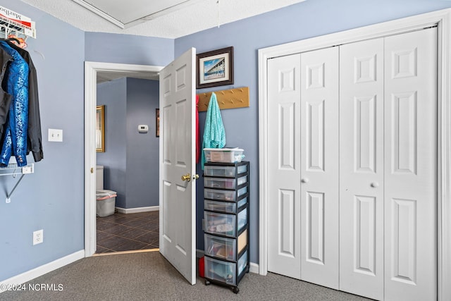 bedroom with tile patterned flooring and a closet