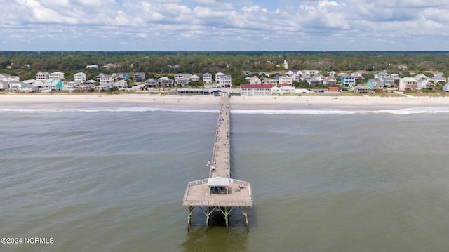 drone / aerial view with a water view and a beach view