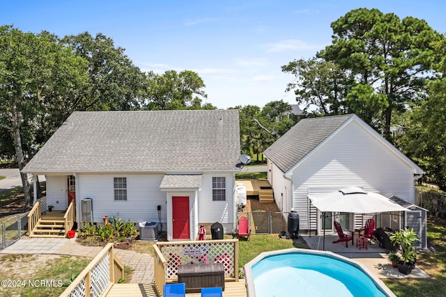 back of house featuring central AC, a patio area, and a gazebo