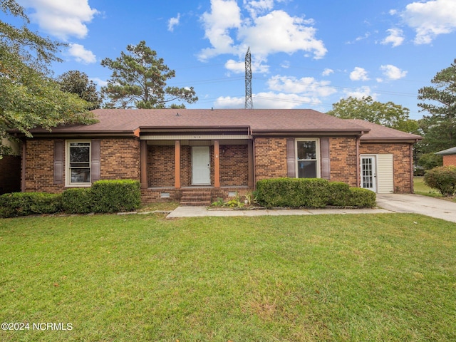 single story home featuring roof with shingles, brick siding, and a front lawn