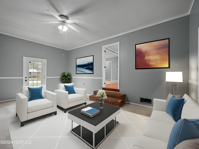 living room with ornamental molding, light tile patterned flooring, and ceiling fan