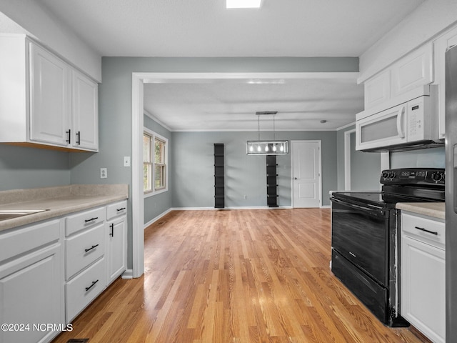 kitchen with black electric range, light hardwood / wood-style flooring, white cabinetry, and pendant lighting