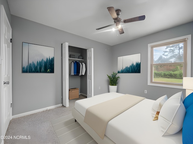 bedroom featuring a ceiling fan, baseboards, a closet, and light colored carpet